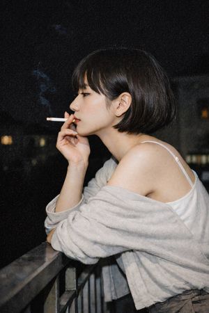 Cinematic Night Portrait of a Woman Smoking