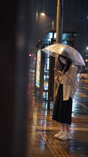 Cinematic rainy night bus stop prompt