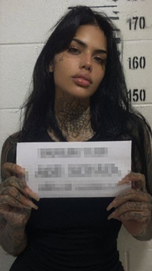 Gritty Tattooed Woman Mugshot