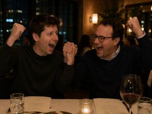 Two Men Celebrating at a Restaurant